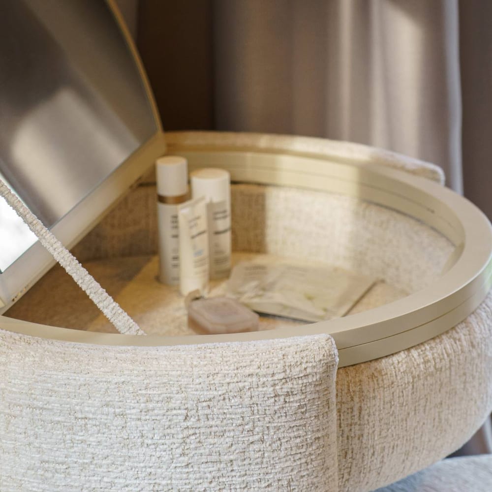 The open vanity, storage well filled with beauty products